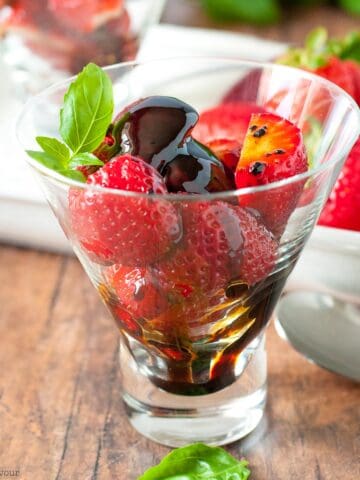 A dessert glass with balsamic strawberries.
