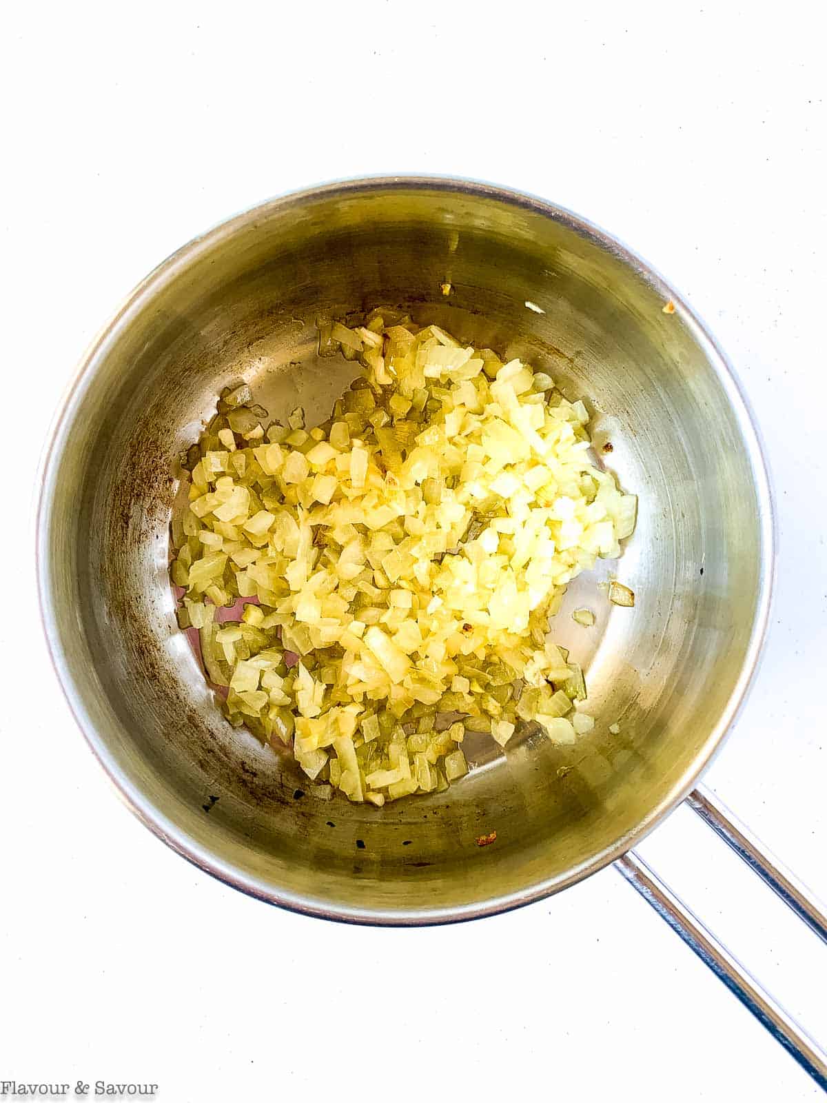 Chopped onions and garlic in a saucepan.