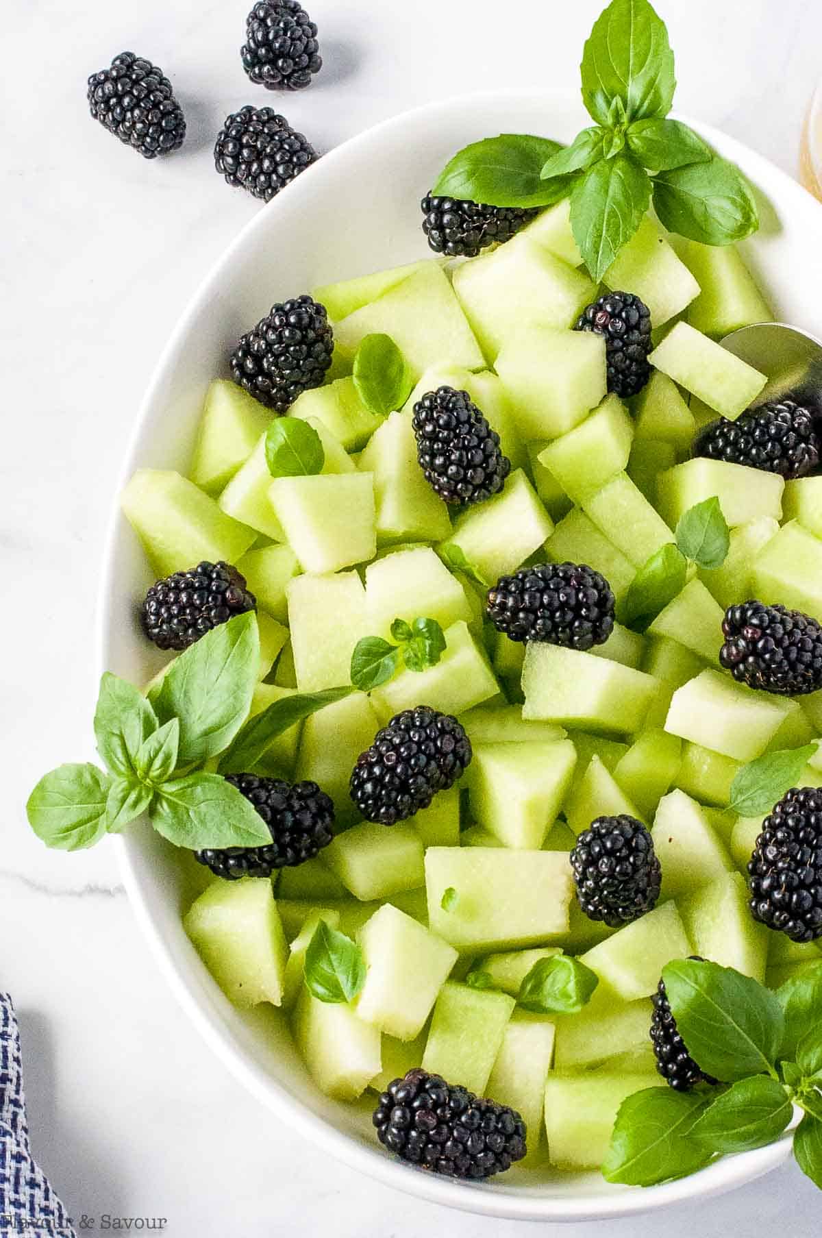 Close-up view of Honeydew Blackberry Salad with Basil.