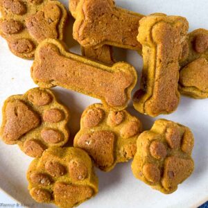 Homemade peanut butter dog treats in a pile.