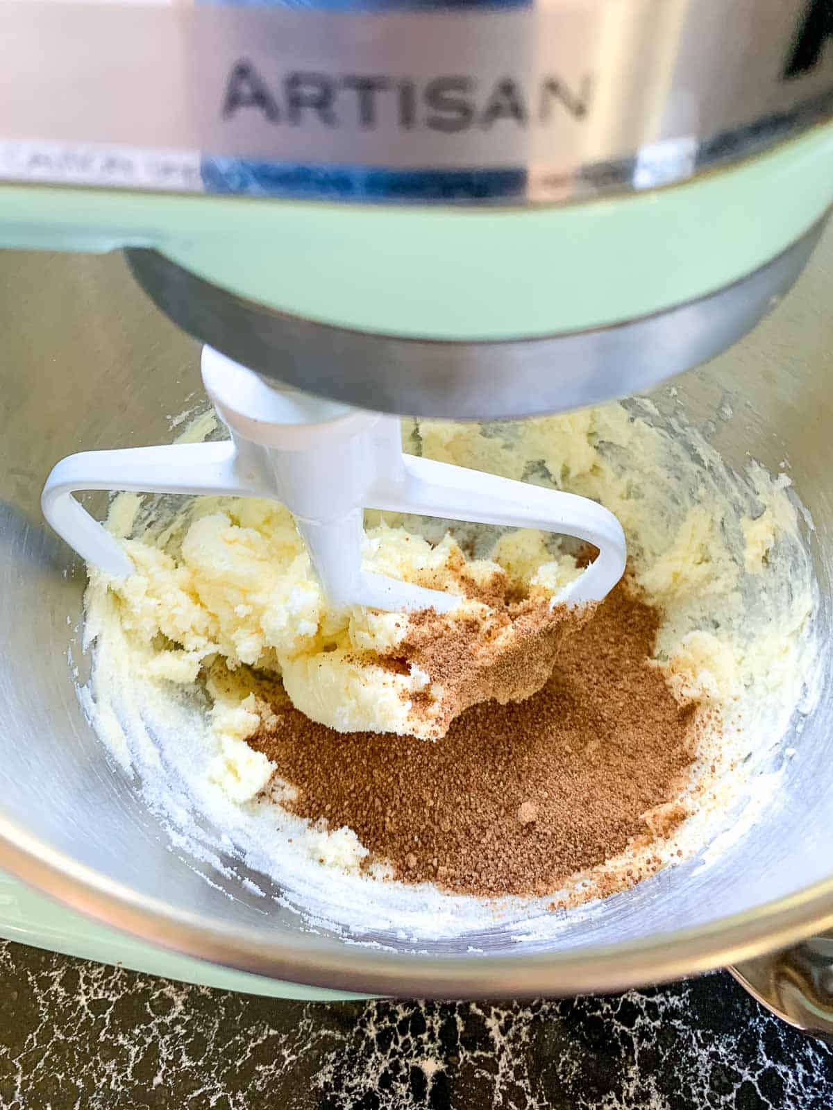 Creaming butter and sugar with an electric mixer.