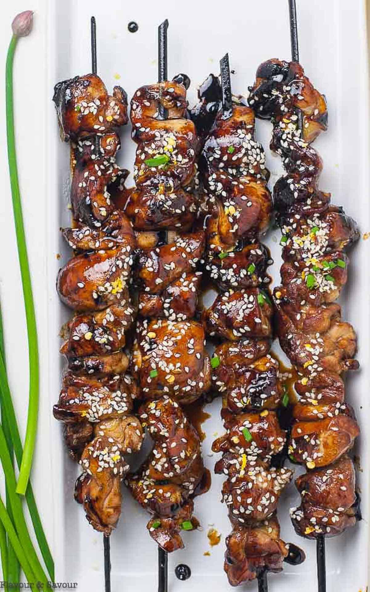 Close up view of chicken yakitori on skewers.