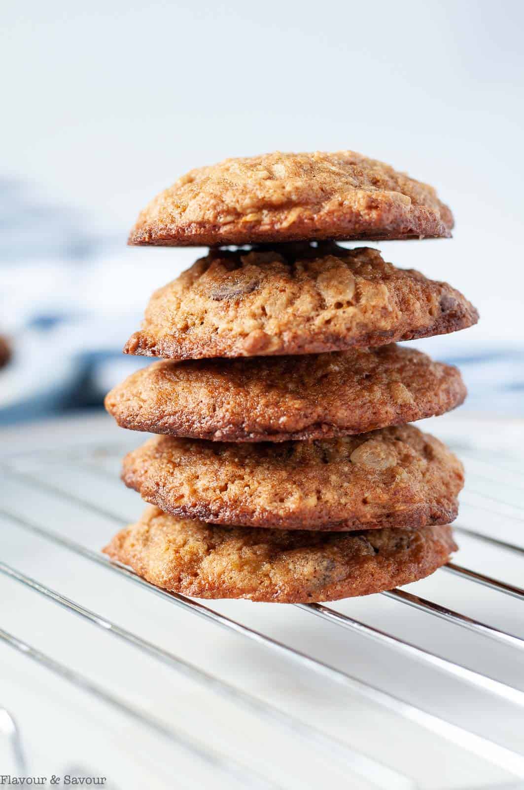 A stack of Gluten-free Banana Bread Chocolate Chip Cookies on a cooling rack.