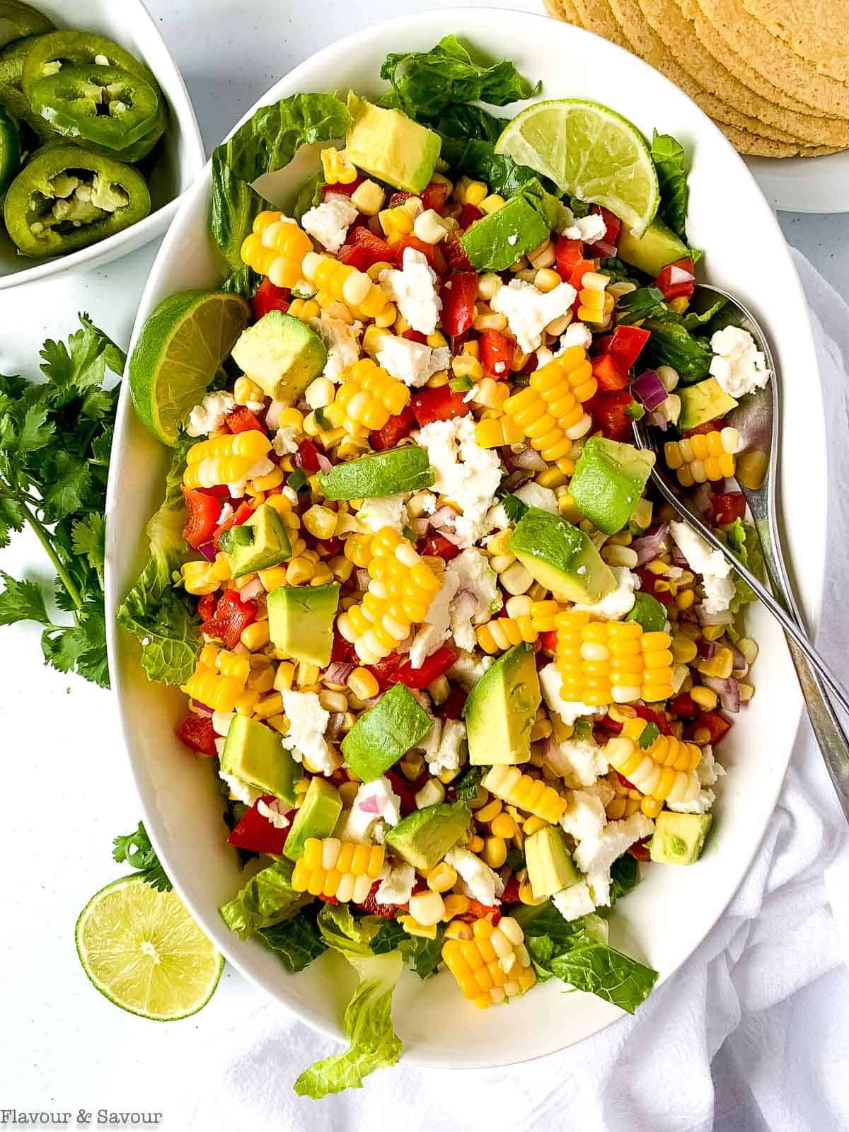 Mexican Corn Salad with Queso Fresco in an oval bowl.