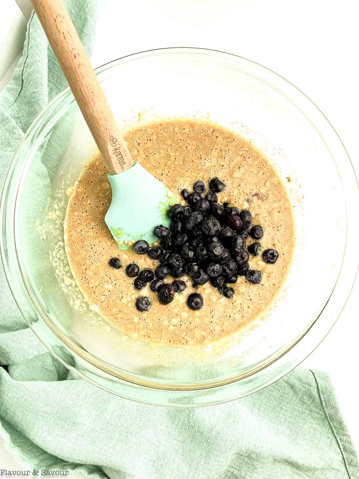 Adding blueberries to batter for blueberry oat bars.