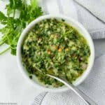 A bowl of homemade chimichurri sauce.