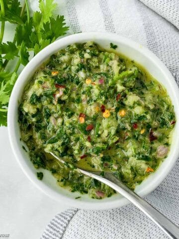 A bowl of homemade chimichurri sauce.