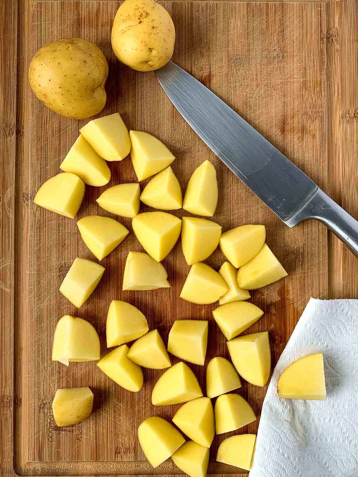 Chopped potatoes on a cutting board.