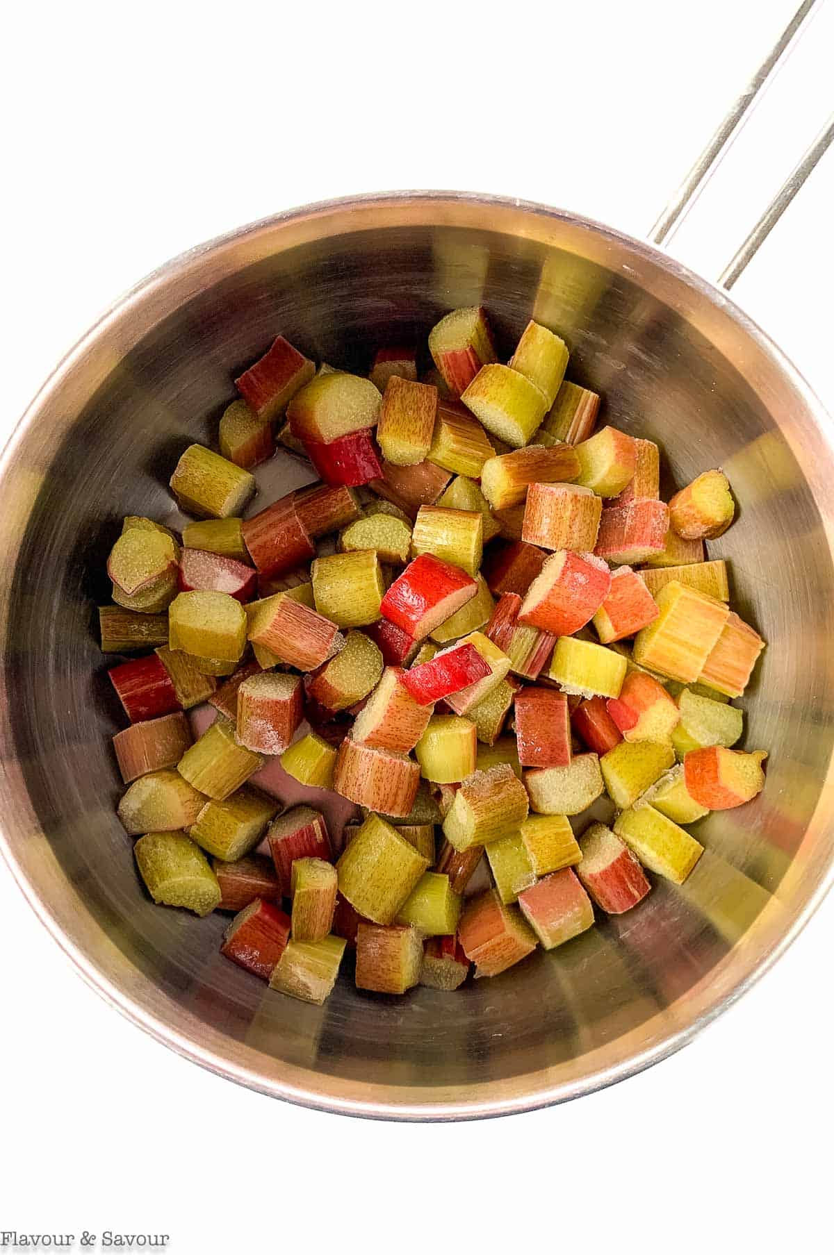 A saucepan with chopped rhubarb pieces.