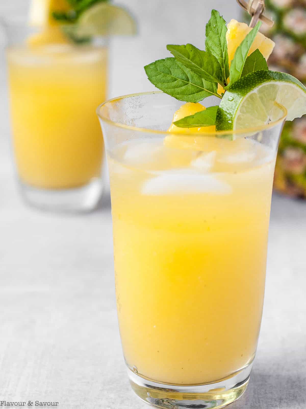 Two glasses of pineapple ginger agua fresca.