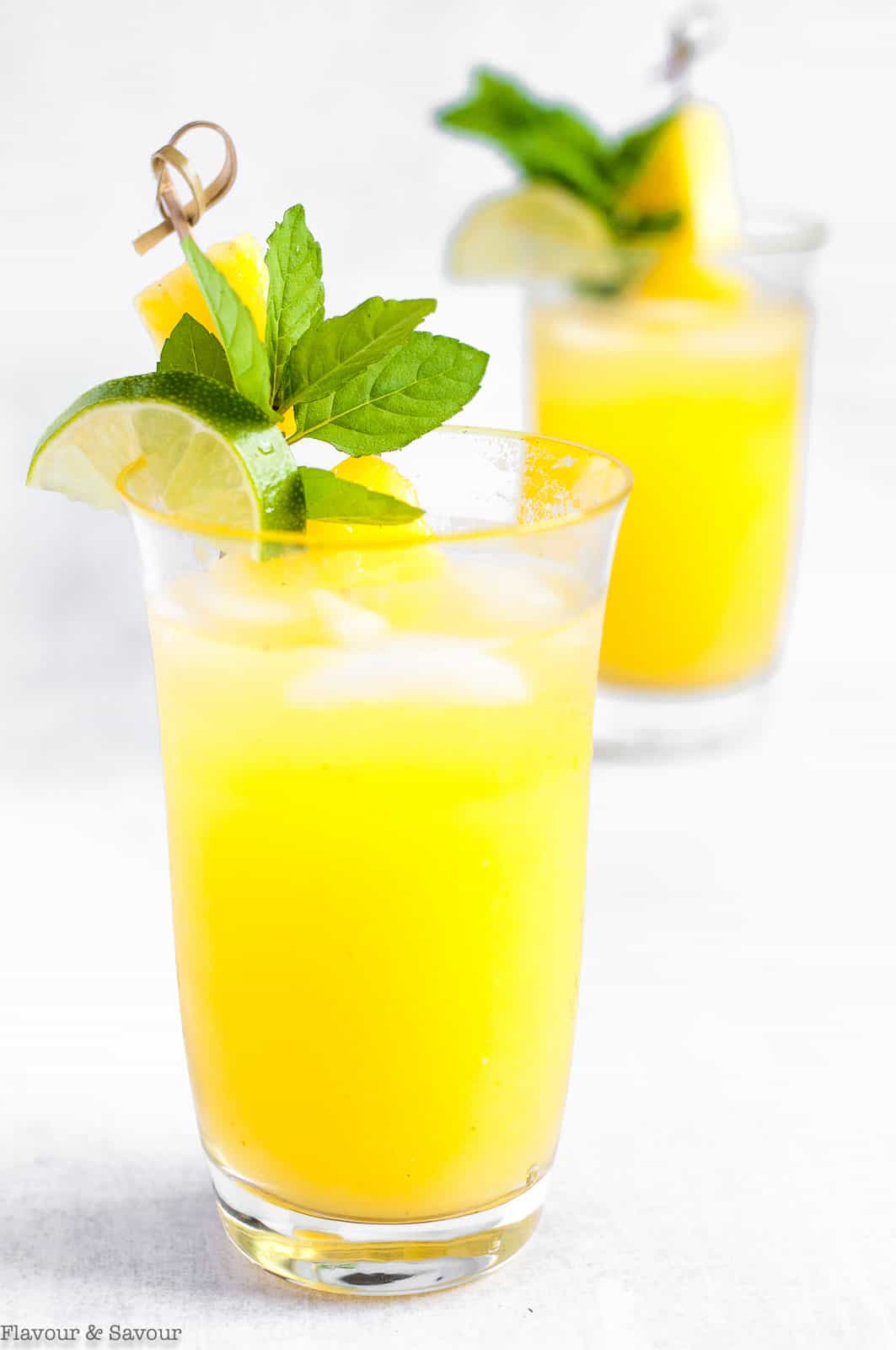 Two glasses of pineapple ginger agua fresca.