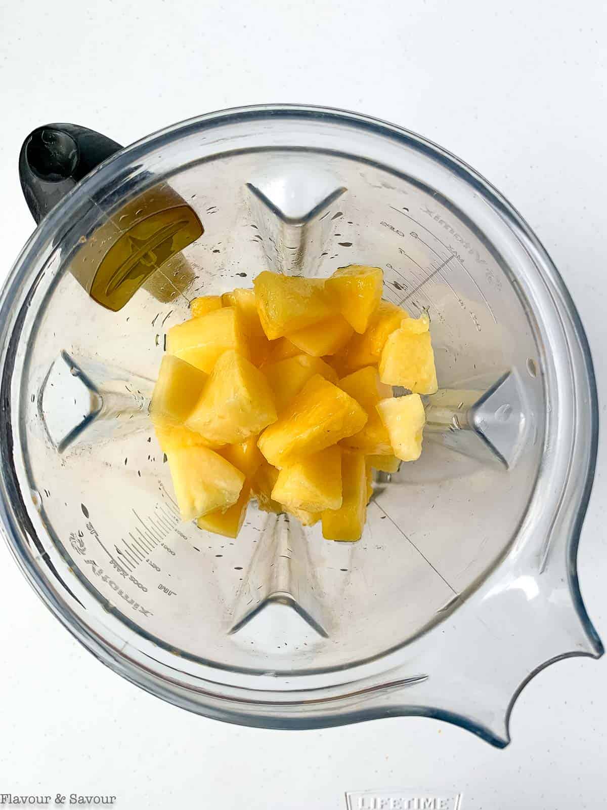 Pineapple cubes in a blender.
