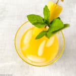 A glass of pineapple ginger agua fresca, overhead view.