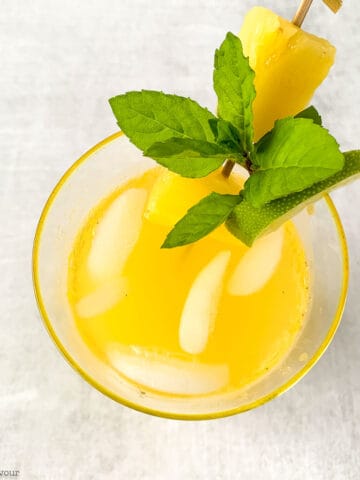 A glass of pineapple ginger agua fresca, overhead view.