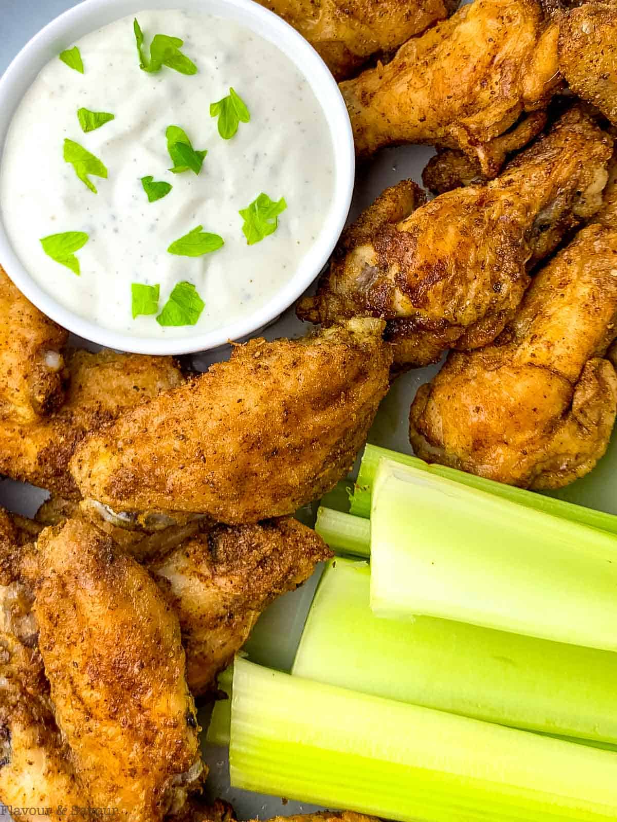 Close up view of Old Bay chicken wings cooked in an air fryer.