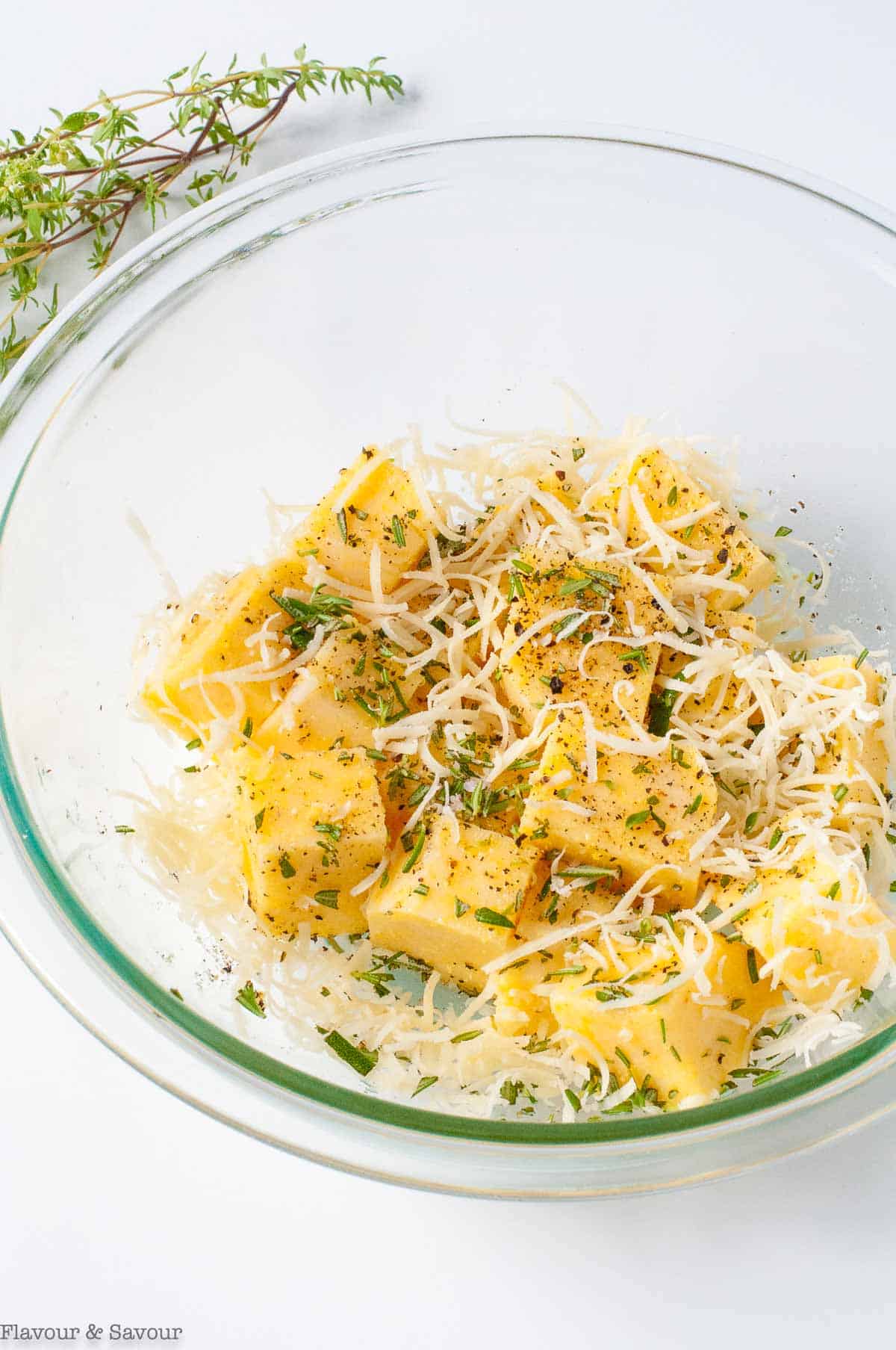 Unbaked polenta croutons in a glass bowl.