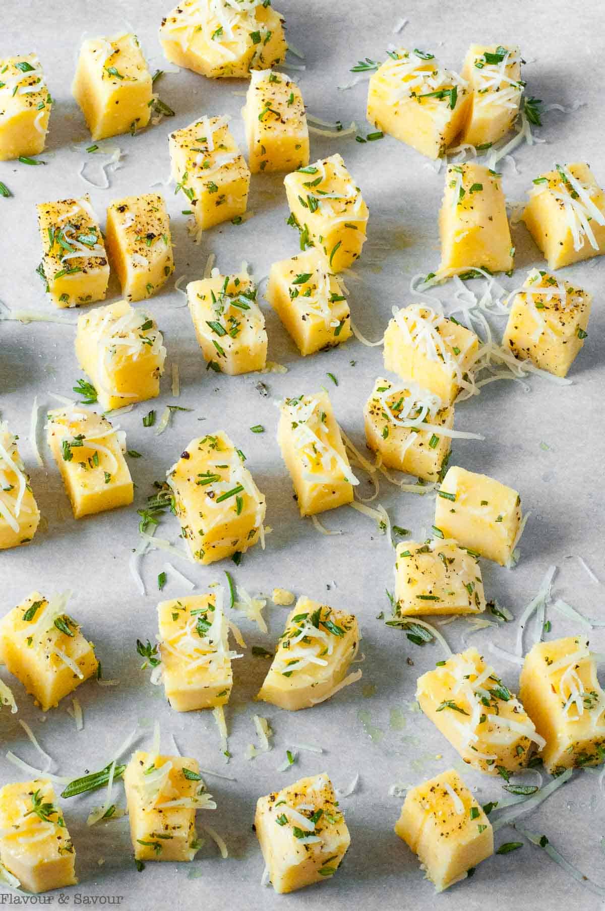 Baked polenta croutons on a baking sheet.