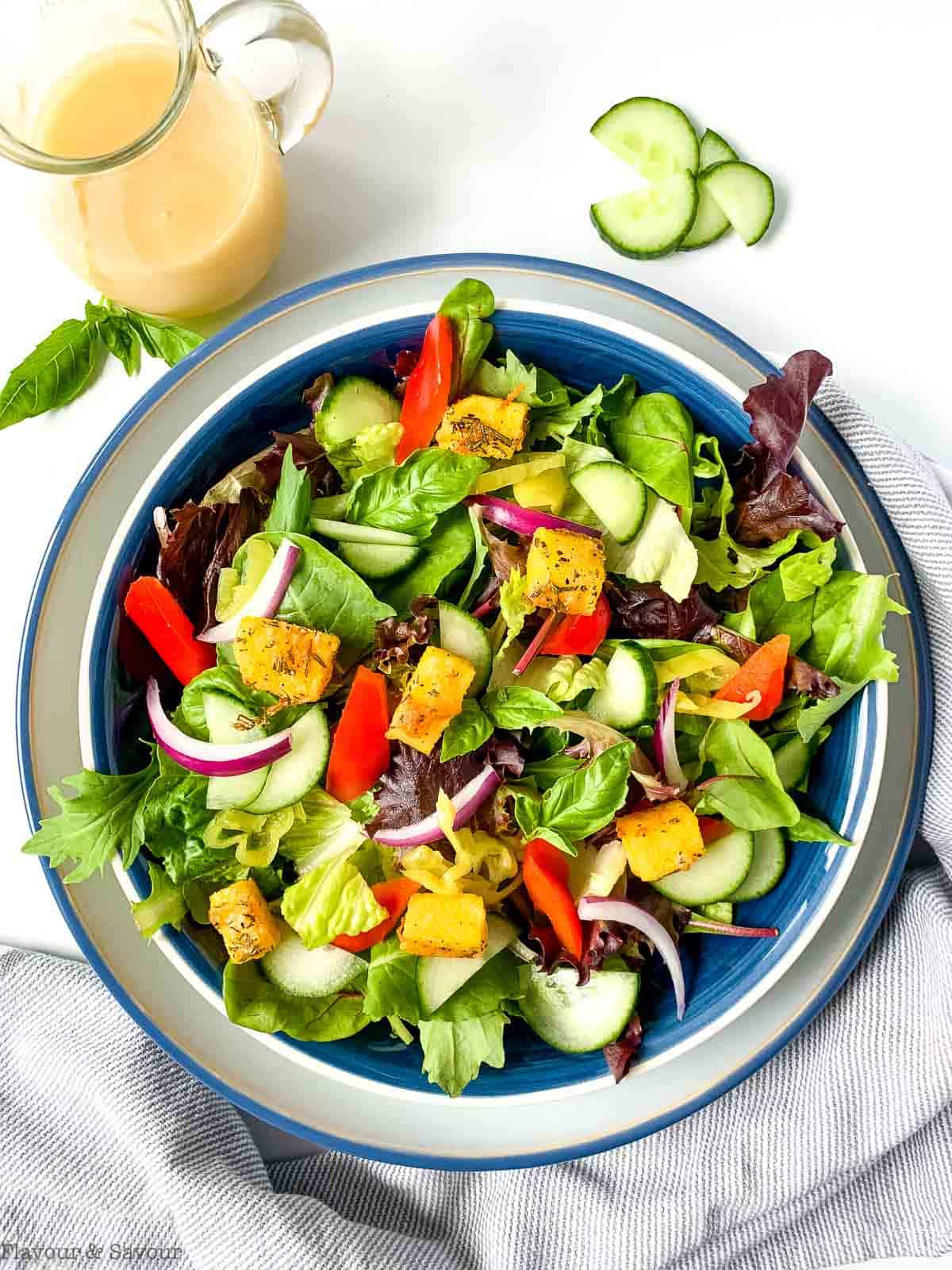 Oven-baked polenta croutons on a green salad.