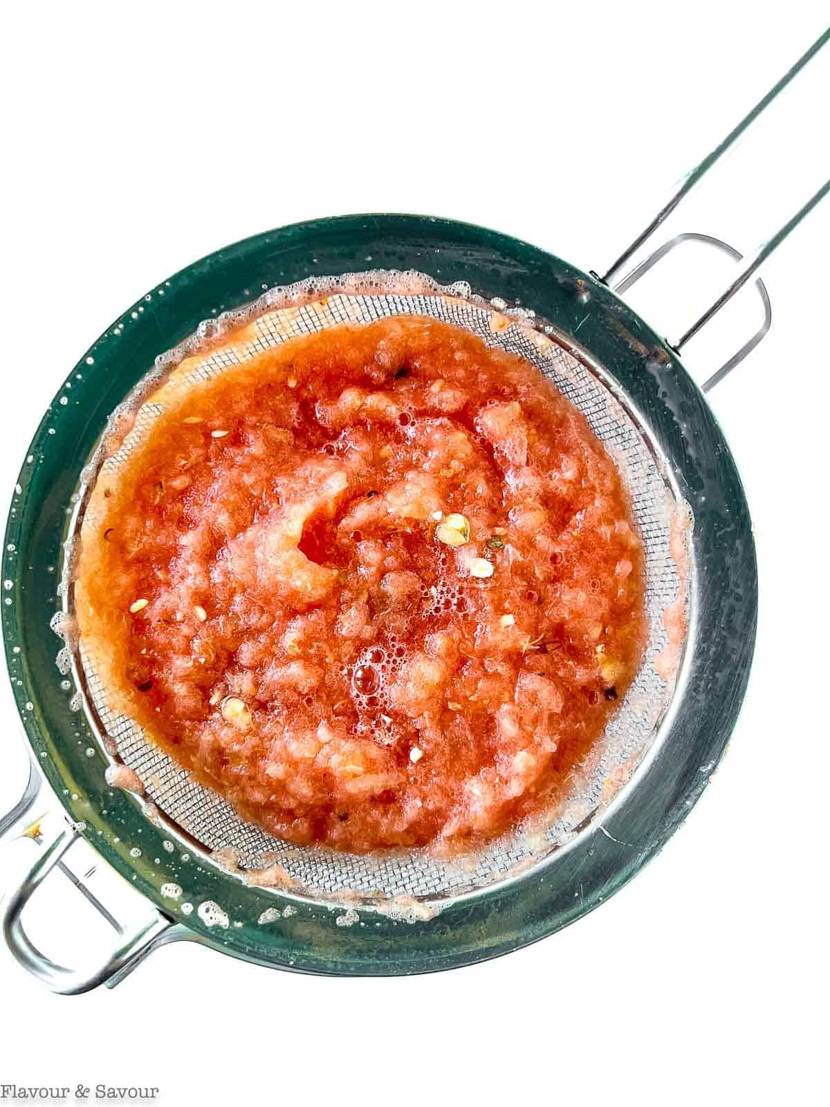 Watermelon and lemon pulp in a sieve.