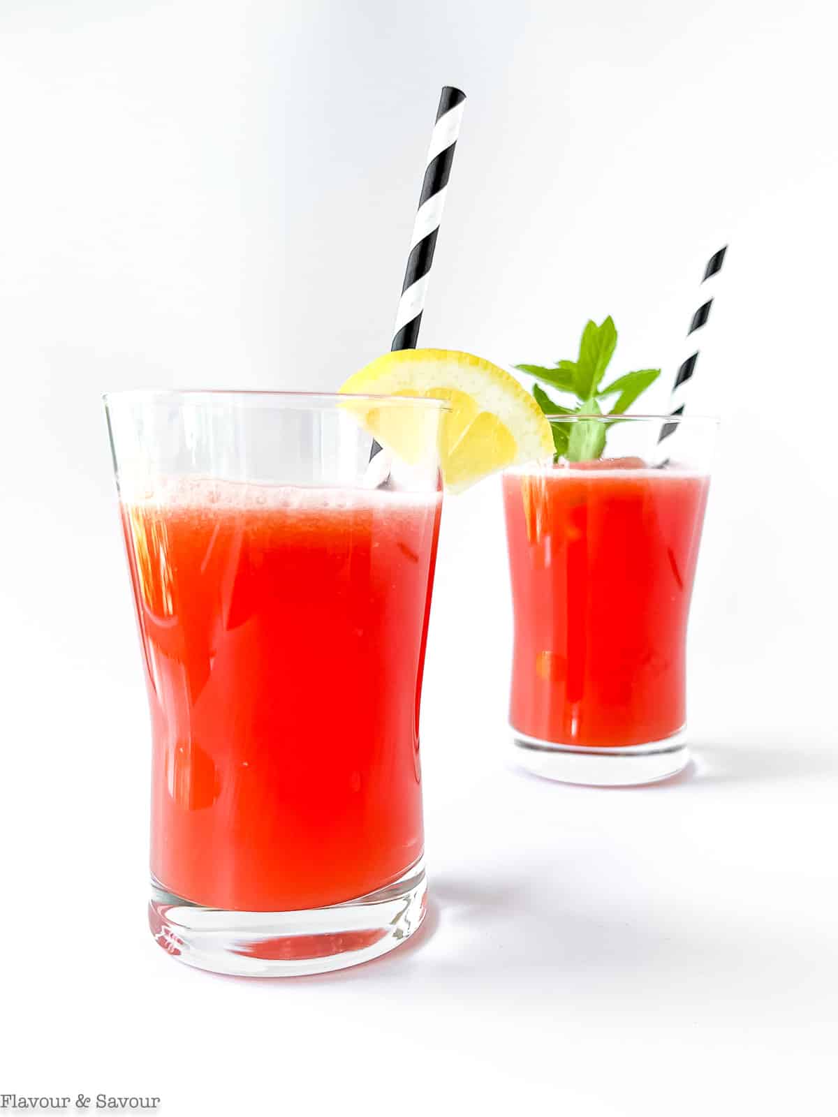 Two glasses of sugar-free watermelon lemonade with straws.