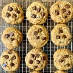 Gluten-free chewy chocolate chip cookies on a cooling rack.