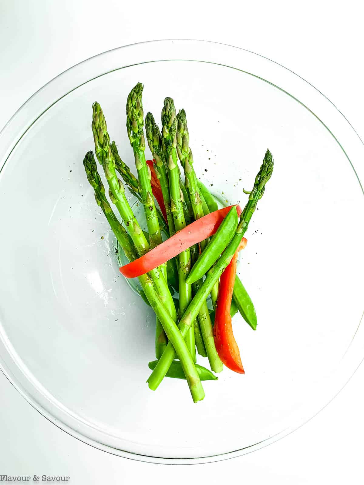 Asparagus, peas and red peppers tossed in oil.