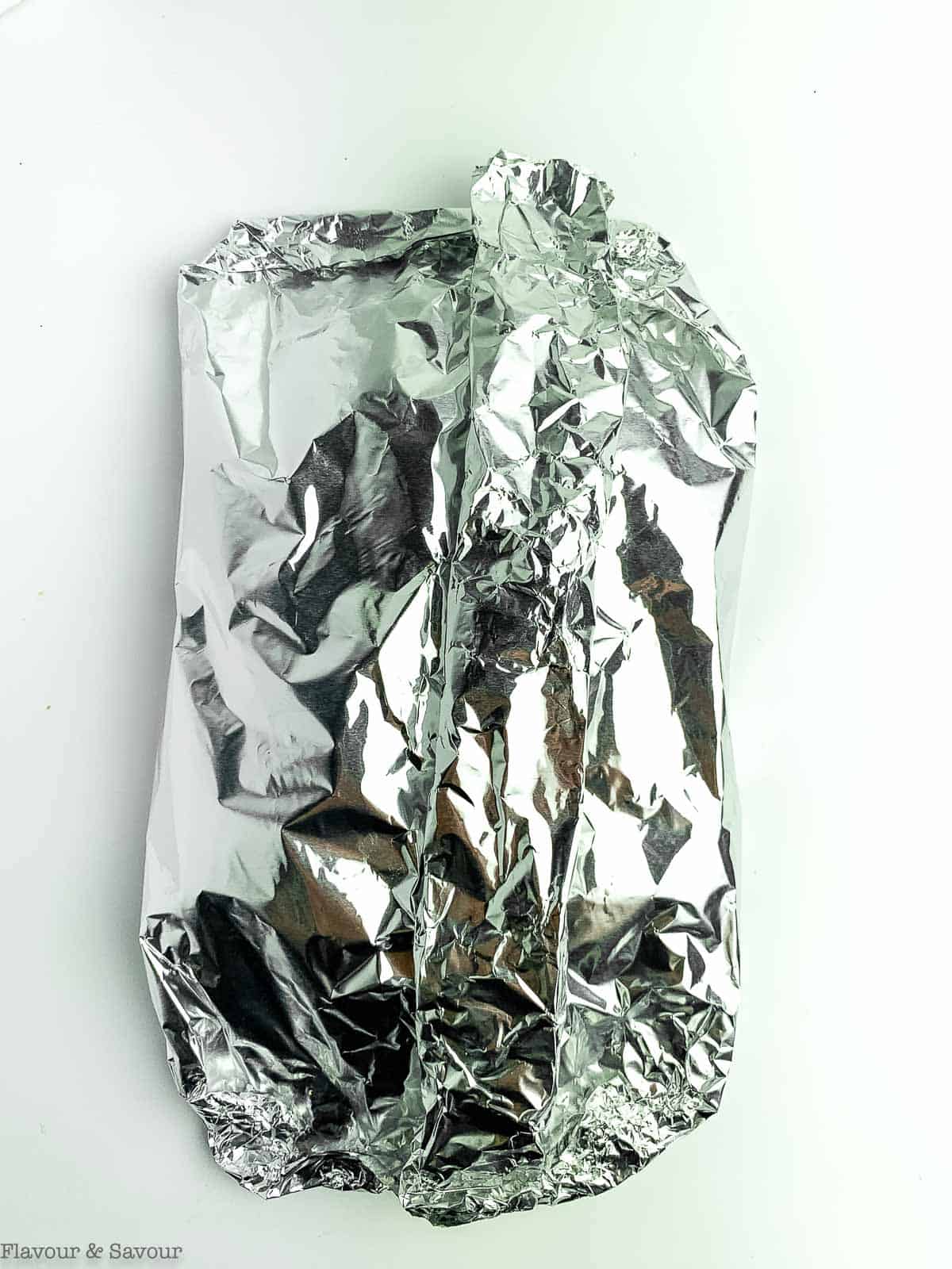 A foil packet of salmon and vegetables.