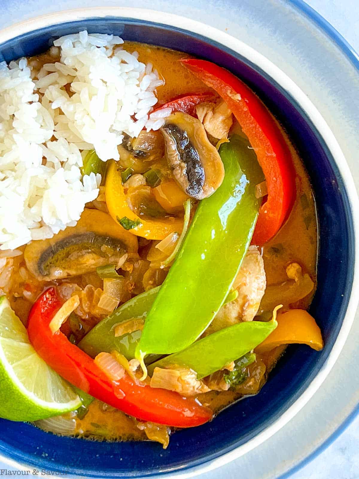 Close up view of Thai red curry with chicken and vegetables.