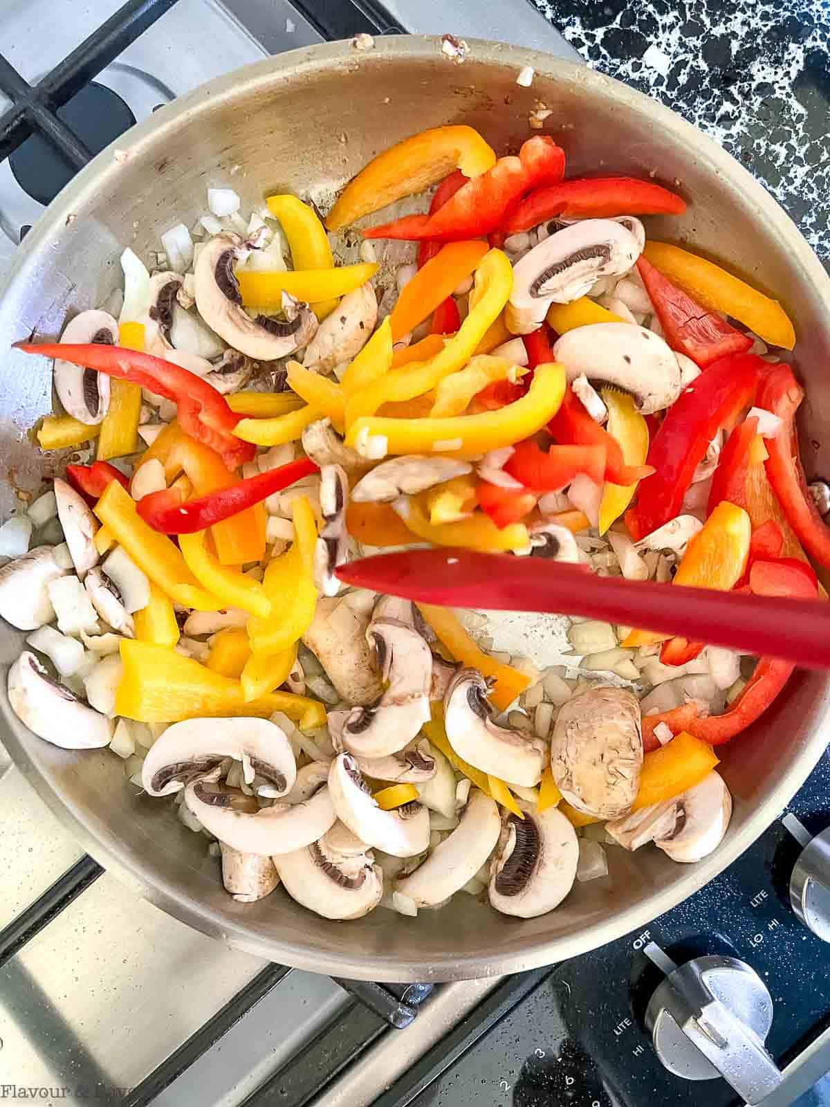Sautéing vegetables for Thai red curry with chicken.