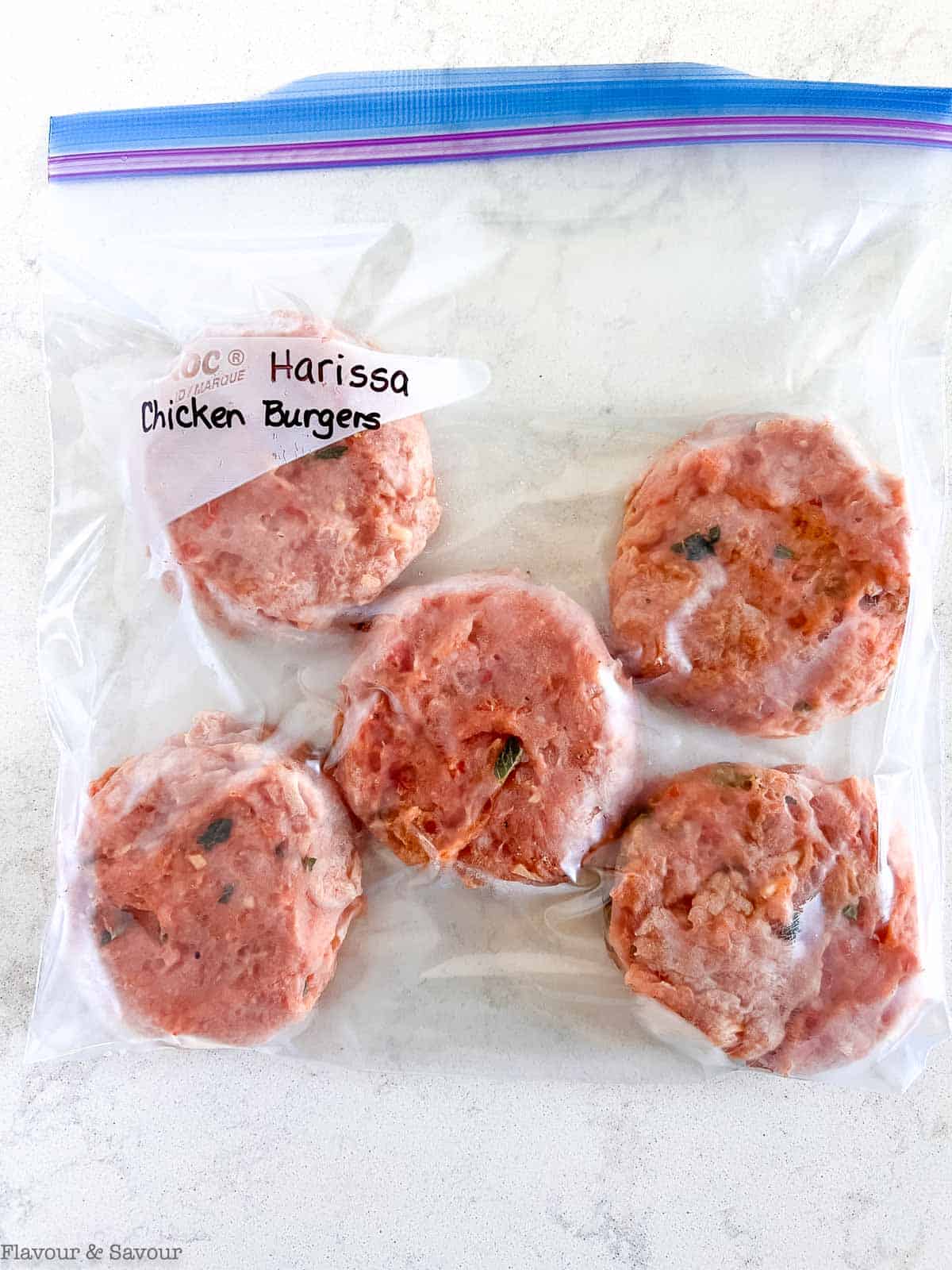 Frozen chicken burgers in a freezer bag.