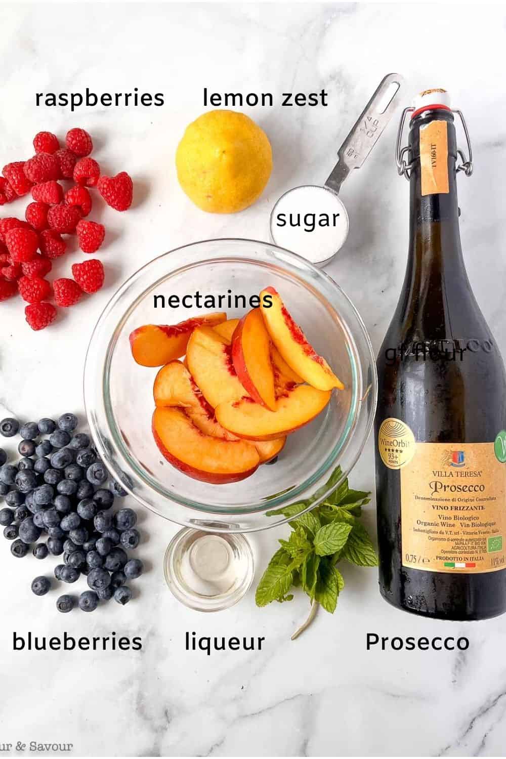 Labelled ingredients for nectarines and berries in Prosecco.
