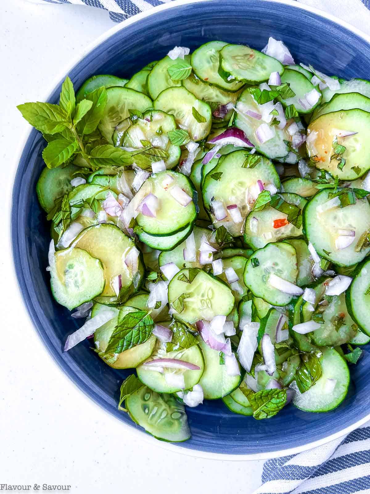 Close up view of Thai Cucumber Salad with spicy Thai dressing and fresh mint.