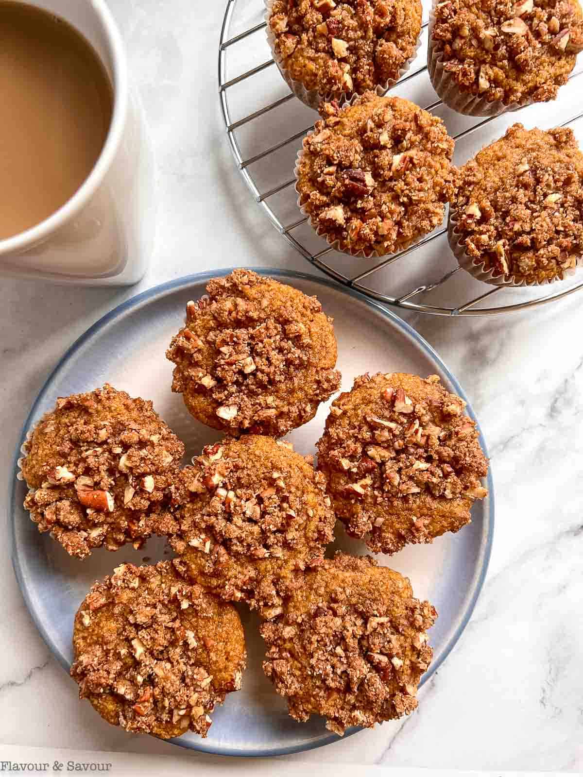 Overhead view of pumpkin streusel muffins cooling on a wire rack.