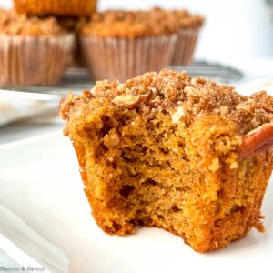 An almond flour pumpkin muffin with a bite out of it.