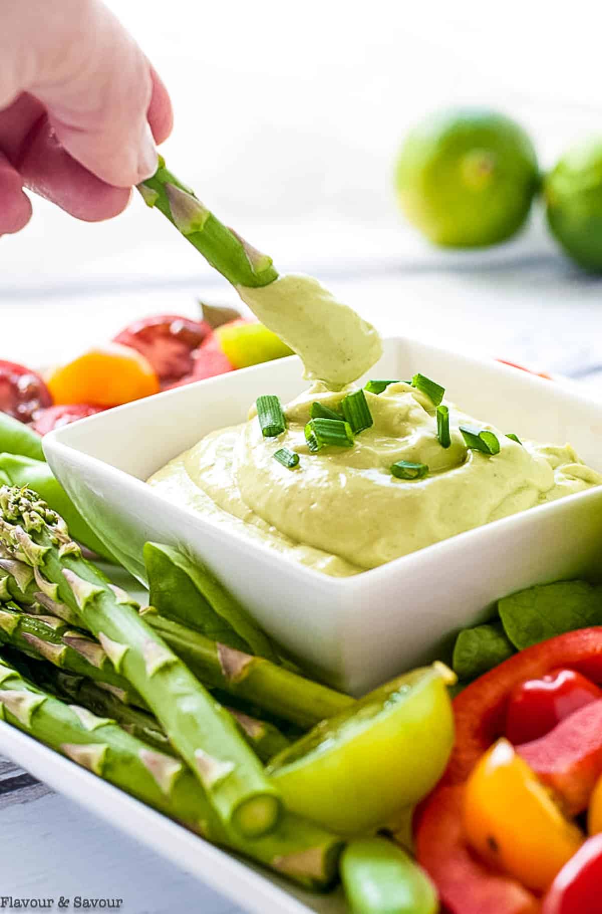 Dipping an asparagus spear into may-free green goddess dip.