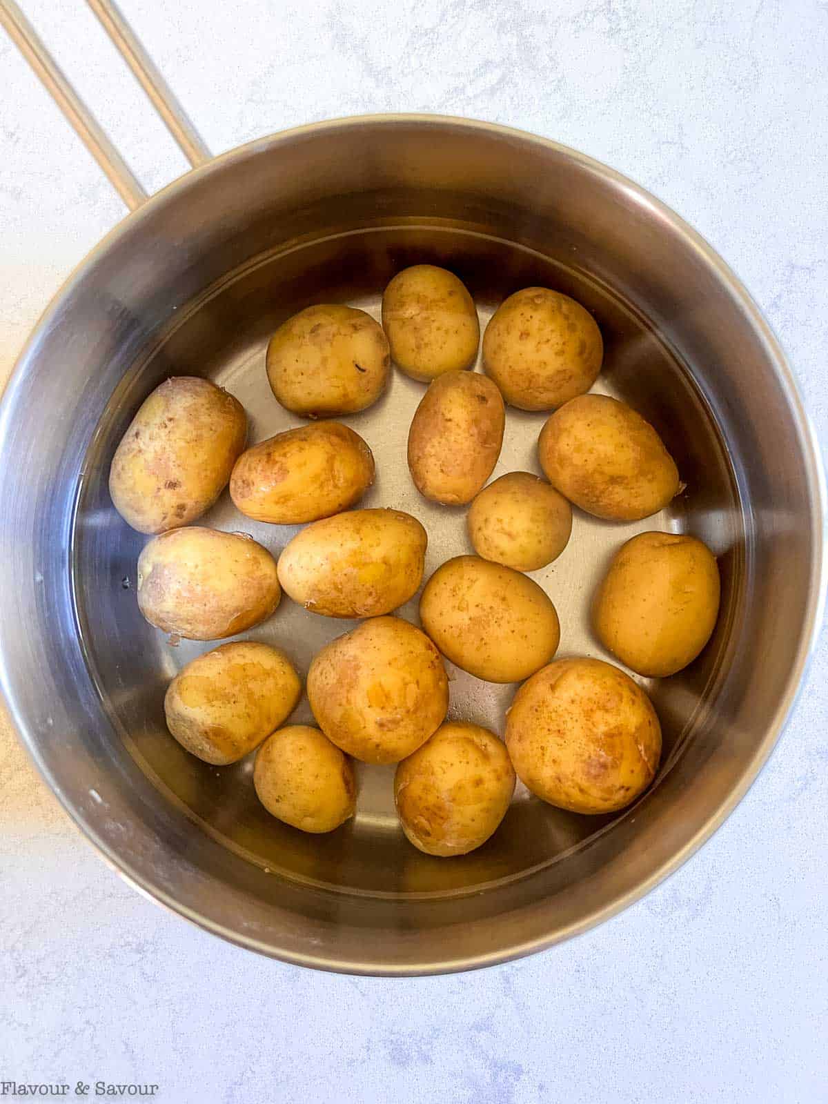 Potatoes in a pot covered with water.