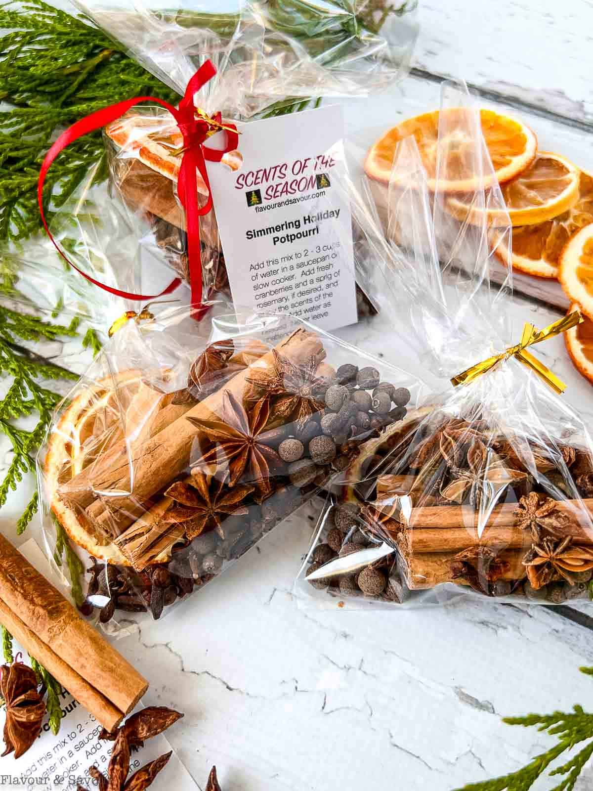 Cellophane packages of dried spice mix with dried oranges to make a Christmas simmer pot.