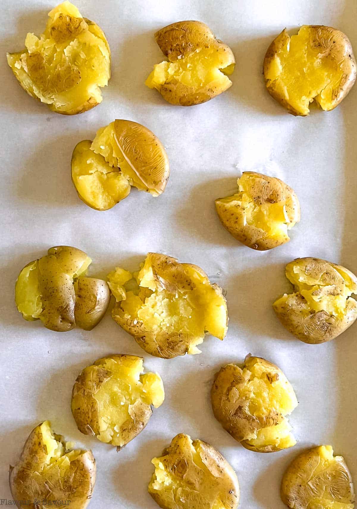 Smashed potatoes on a baking sheet.