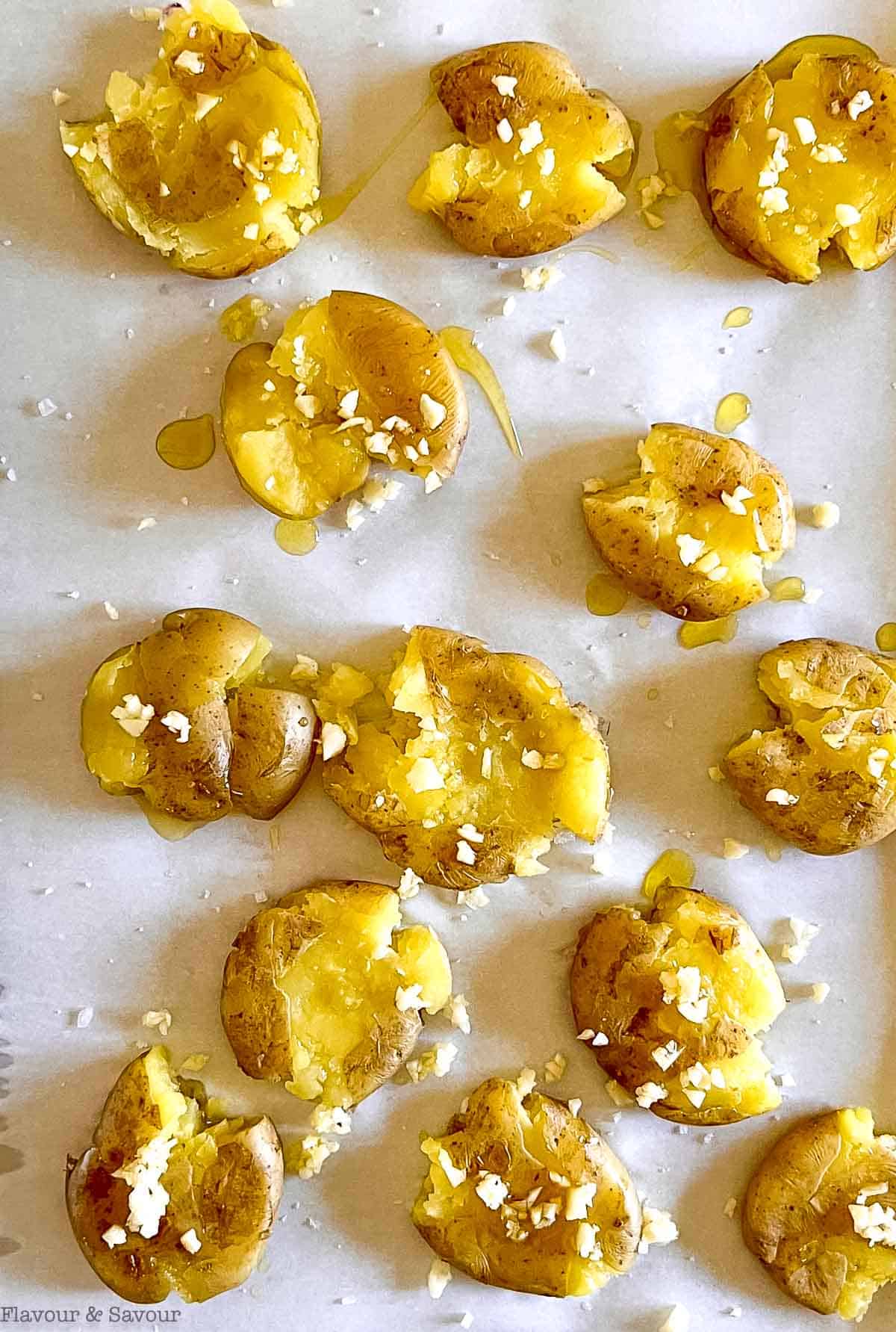 Smashed potatoes sprinkled with olive oil, coarse salt and minced garlic.