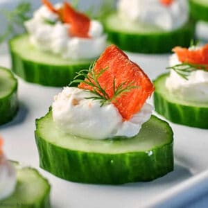 Close up view of a single smoked salmon cucumber bite with cream cheese and smoked salmon.