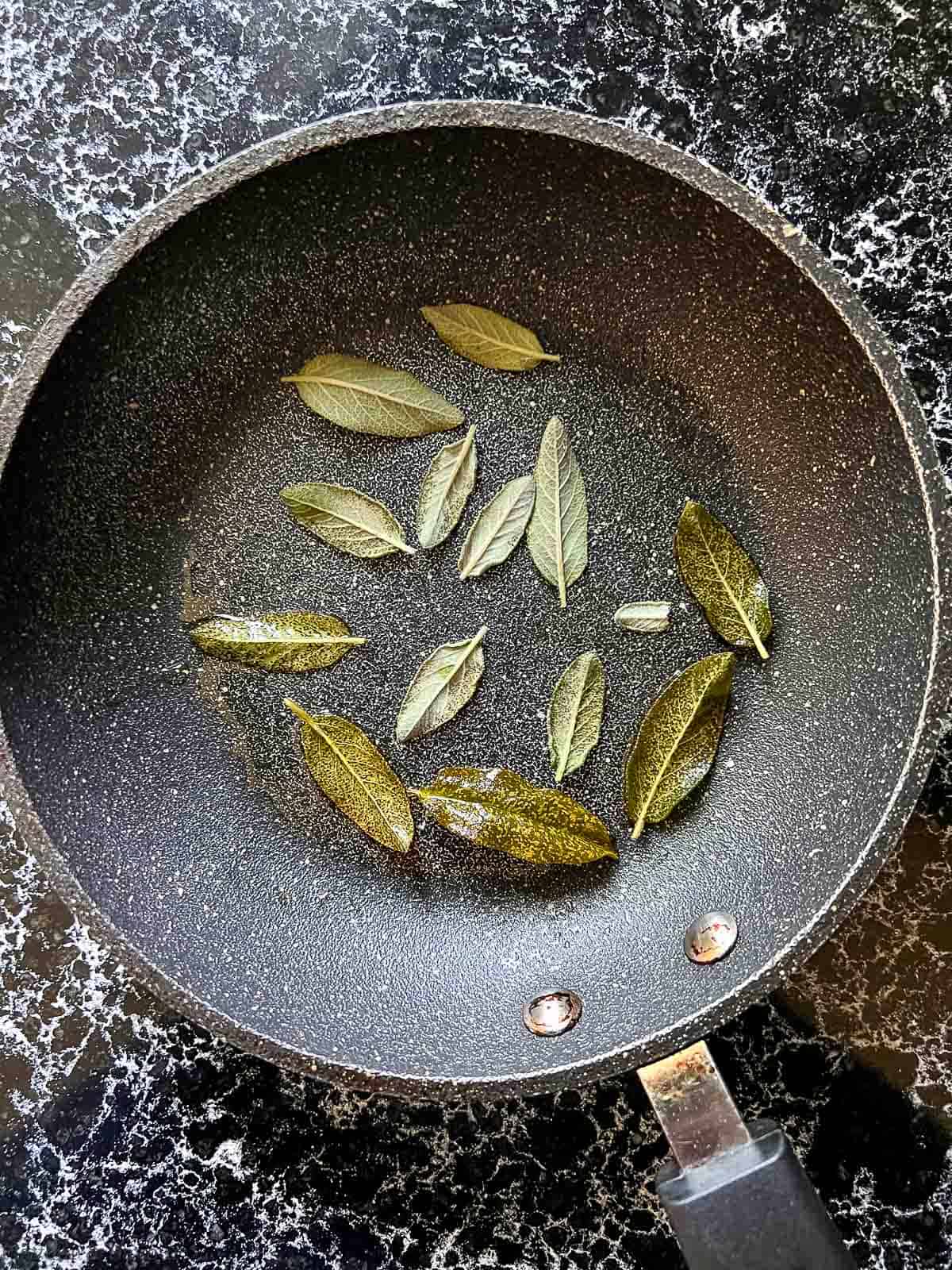 Sage leaves in a non-stick skillet.