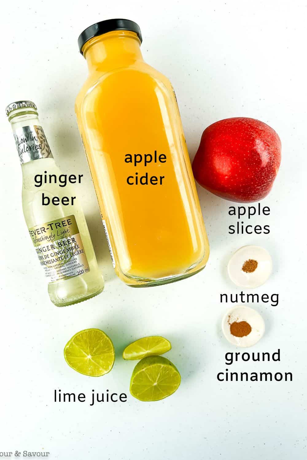 Labelled ingredients for apple cider ginger beer mocktail.