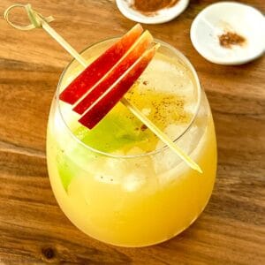 Apple Cider Ginger Beer Mocktail garnished with apple slices.