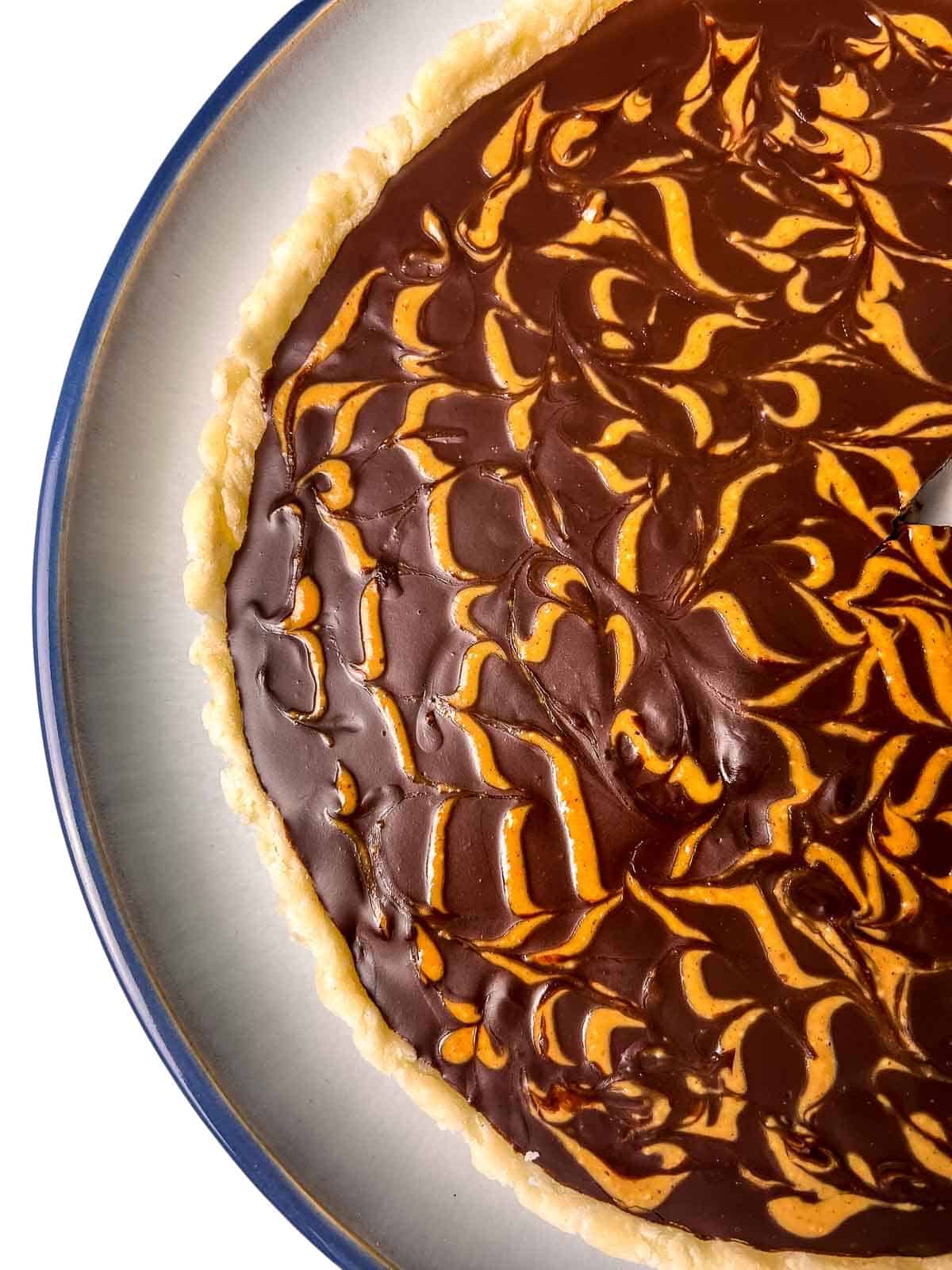 Peanut butter swirls on chocolate peanut butter swirl pie.