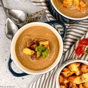 Creamy mushroom soup made with cauliflower in a bowl with gluten-free croutons.