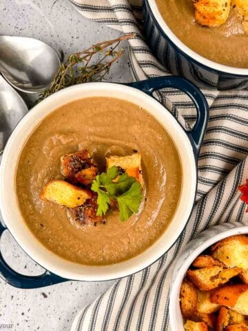 Creamy mushroom soup made with cauliflower in a bowl with gluten-free croutons.