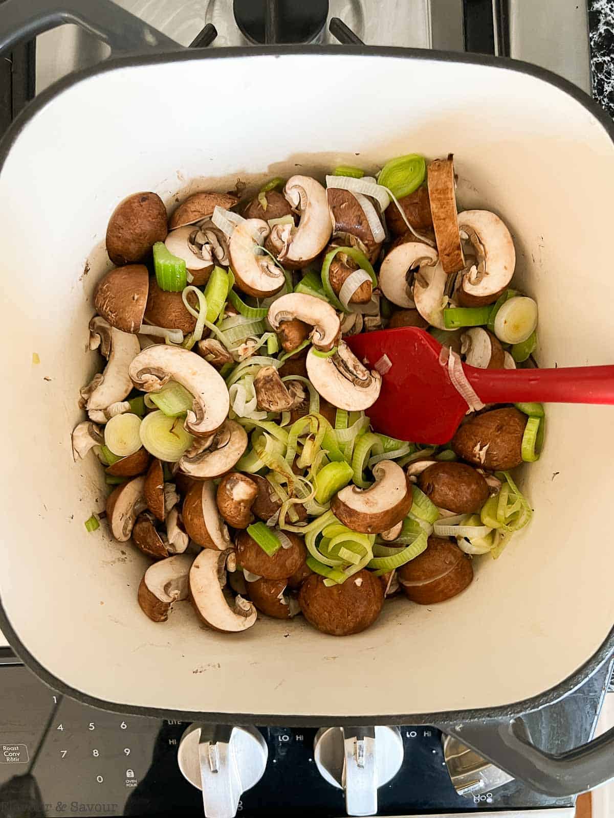 Sautéing mushrooms with leeks and celery.