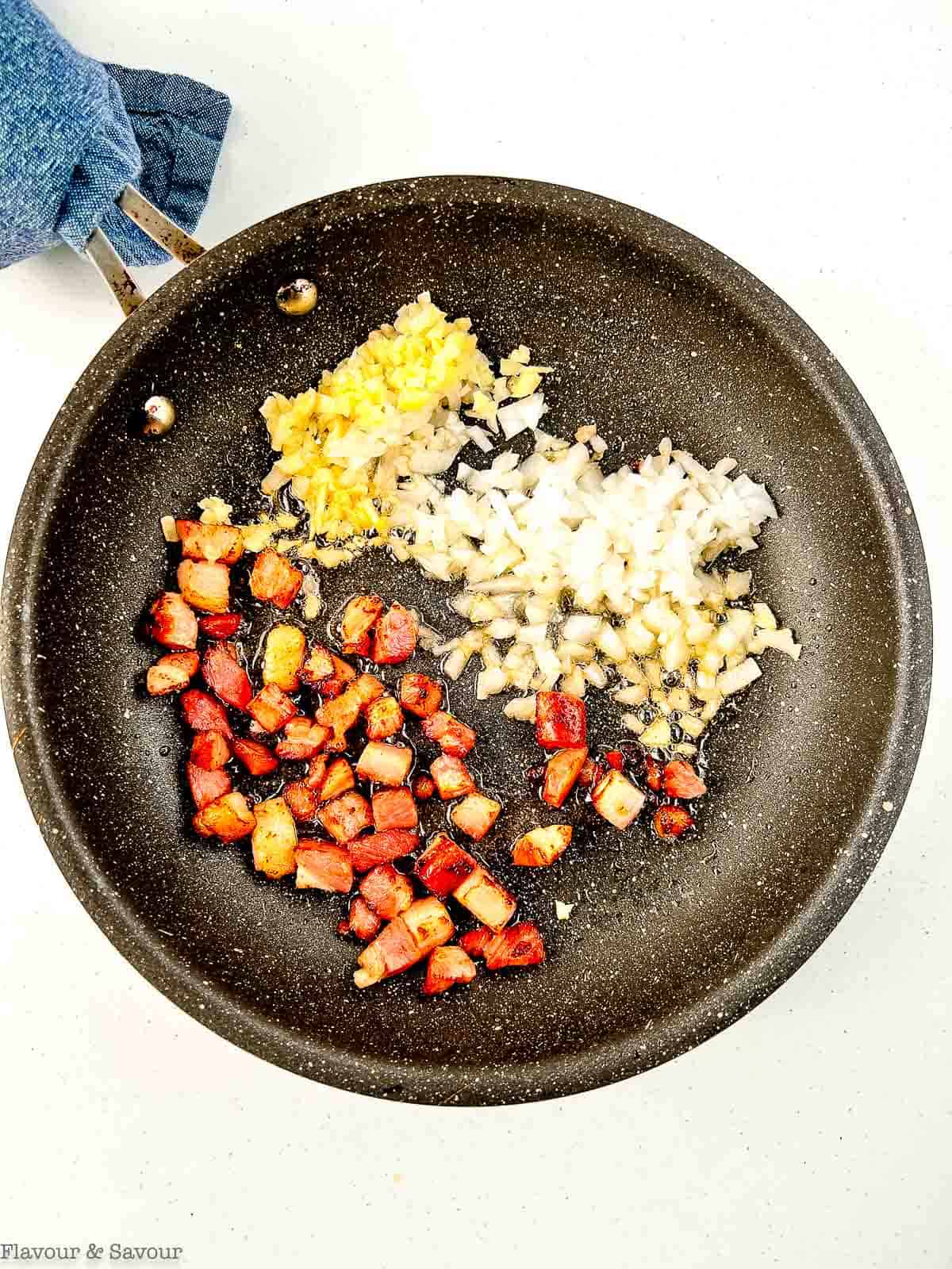 Pancetta, onions and garlic in a skillet.