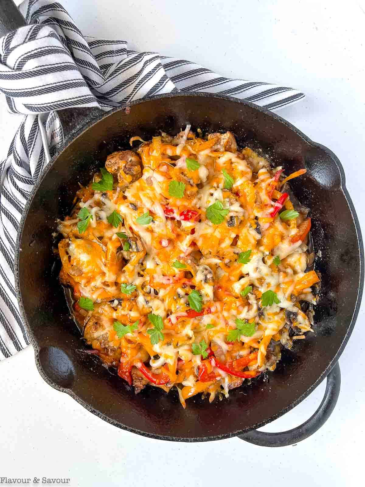 Baked chicken fajita casserole in a cast iron pan.