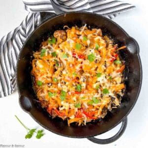 Overhead view of a cast iron skillet with baked chicken fajita casserole.